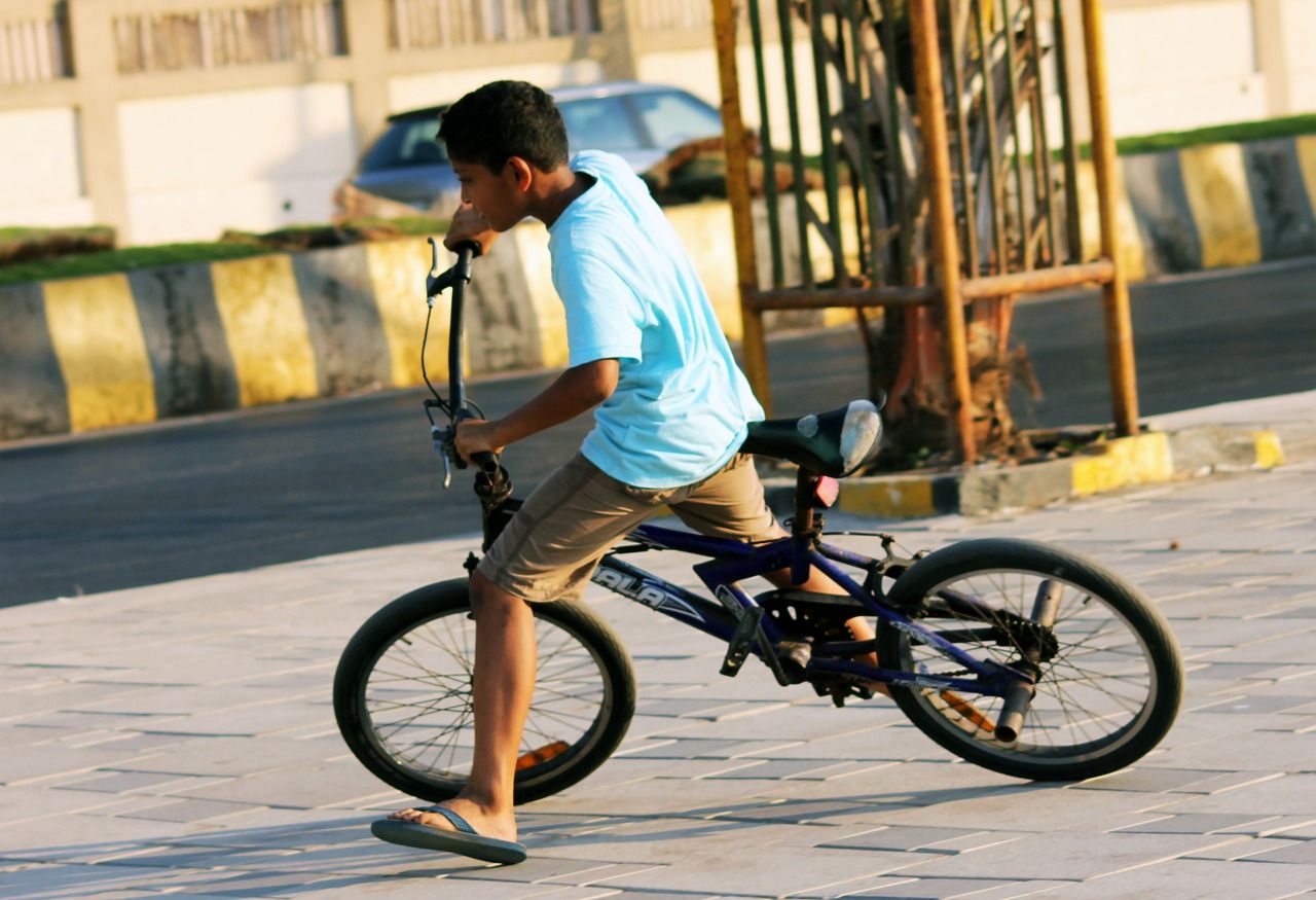 Kid riding a bike uses his brakes to come to a skidding stop Kid riding a bike uses his brakes to come to a skidding stop